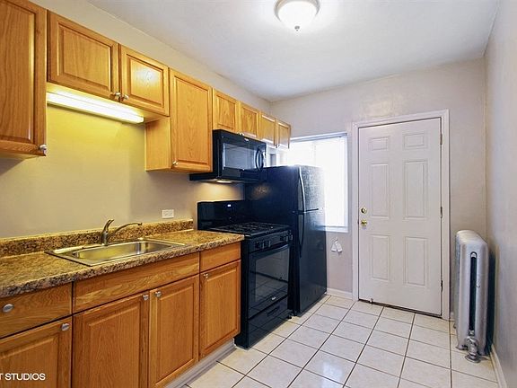 Bright kitchen with black appliances