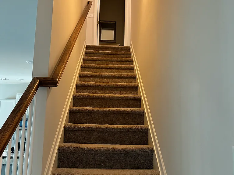 Stairs to 3 bedrooms, two full baths, and laundry area upstairs.