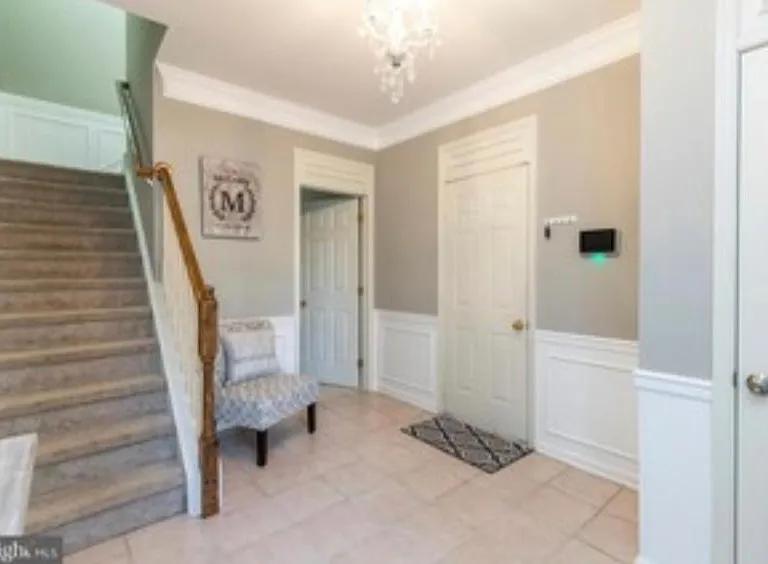 Foyer with closet and garage access. Leads to walk out basement and upstairs to second floor living room and kitchen.