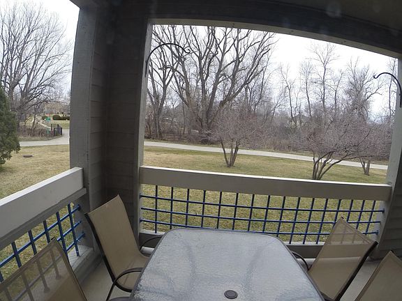 Portion of back deck, this deck wraps around to the primary bedroom with sliding doors from the living room and bedroom. Notice the bike path, creek, and park.