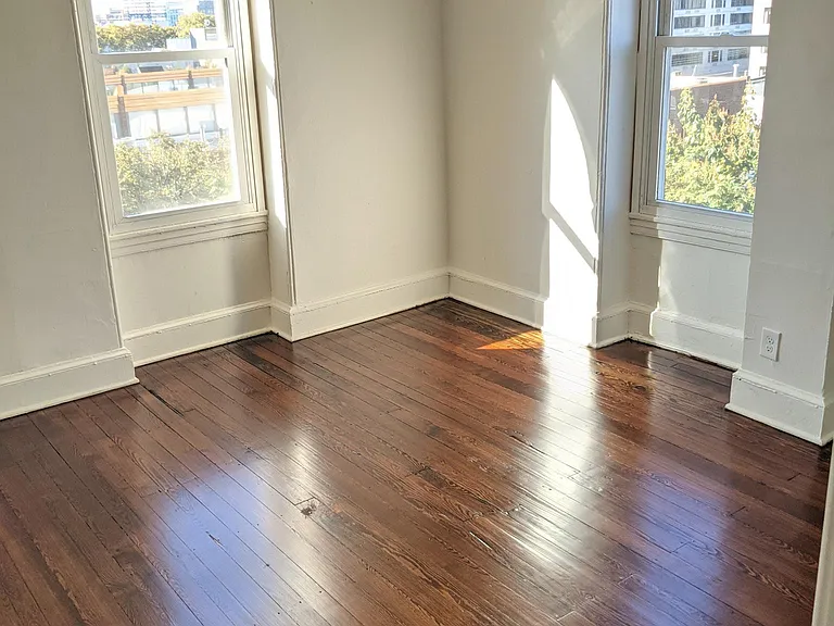 Large bedroom with tons of light, newly refinished wood floors, and a fantastic view of the city skyline!