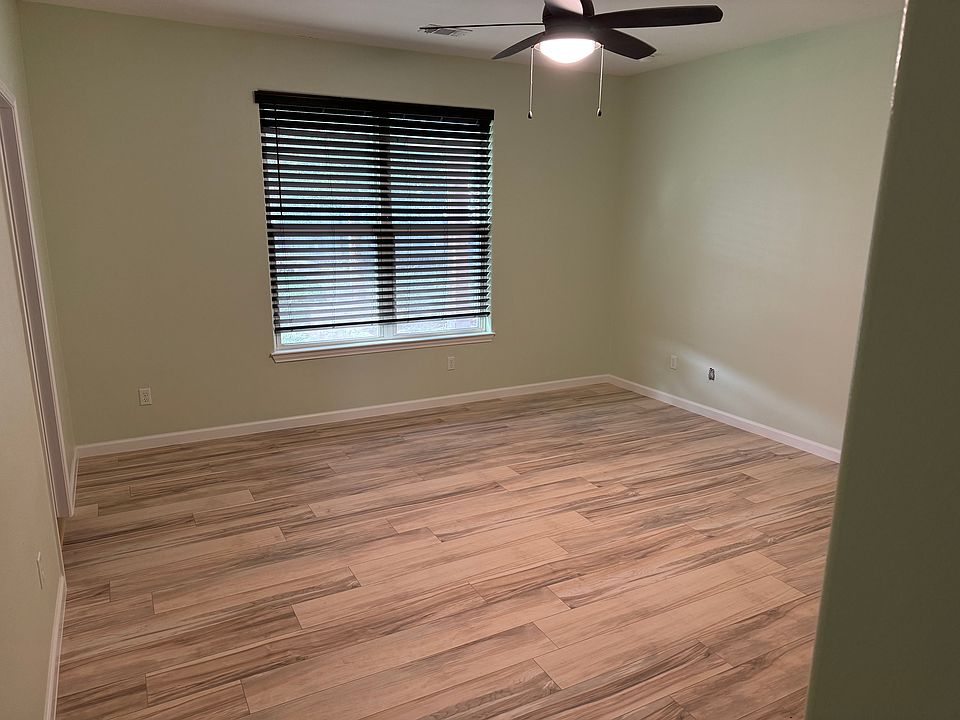 Room with wood floor.