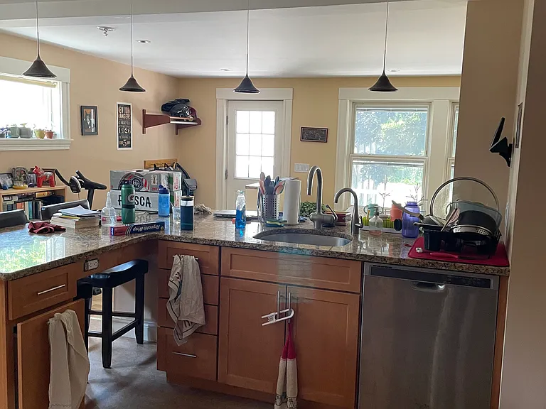 Kitchen with living room and deck beyond