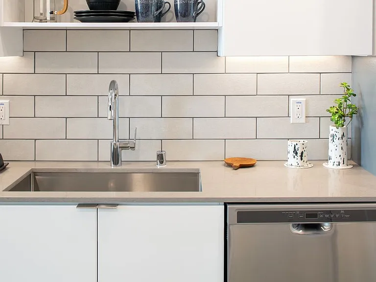 Kitchens with quartz countertops, tile backsplash and stainless steel appliances