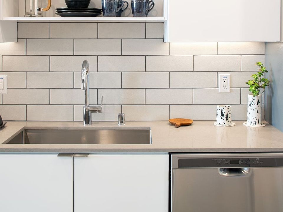 Kitchens with quartz countertops, tile backsplash and stainless steel appliances