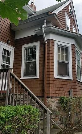 Rear of house with steps to kitchen door.