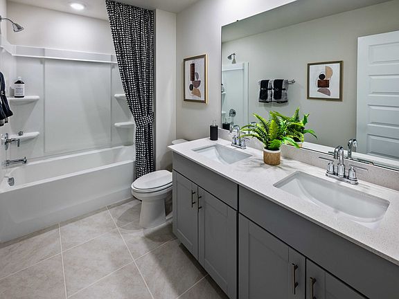 The secondary bath offers a space for guests to get ready. Photography from Holland Park.