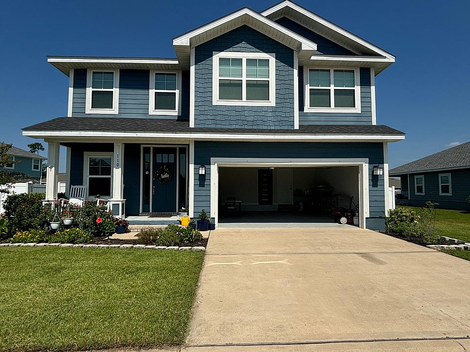 Street view of home. Garage door up.