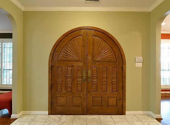 Entryway with Spanish style wooden double door
