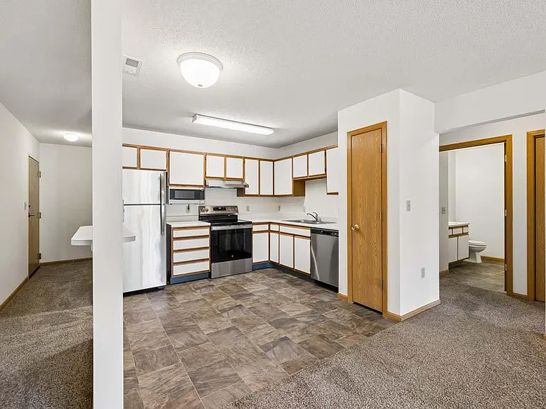 The open layout creates an easy flow between the kitchen and living area, making everyday living feel comfortable and connected.