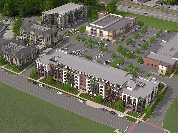 Aerial view of The Hamlet at Saratoga Springs featuring apartment buildings, The Fresh Market, and other retail