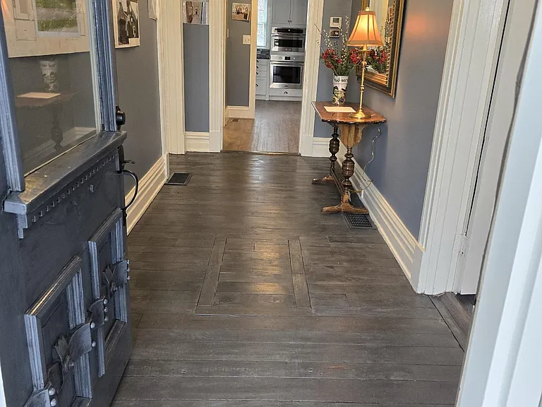 View from Front/S. Winter entrance to back of house/kitchen - main hallway. Note restored original plank flooring.