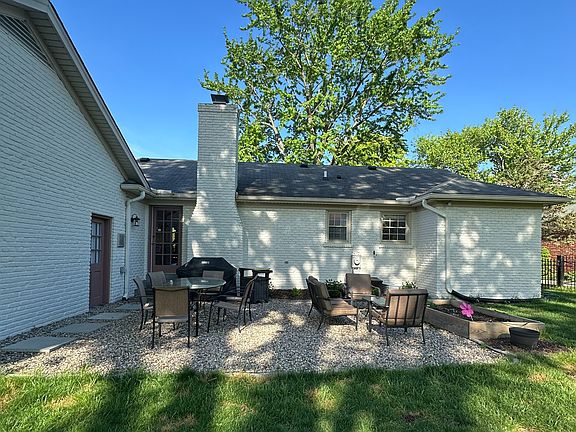 Pea gravel patio with small garden bed.