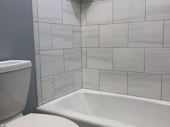 Brand new custom built bathroom, with cast iron tub with porcelain finish, tile etc.