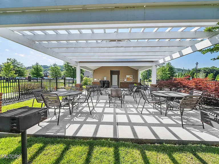 Pergola with plenty of tables and seating. Attached to bathrooms and changing areas