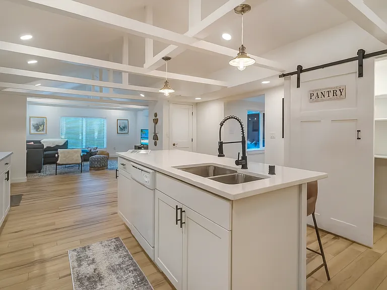 Spacious open-concept kitchen with a large island, sleek finishes, and direct flow into the cozy living room_perfect for entertaining or relaxed nights in