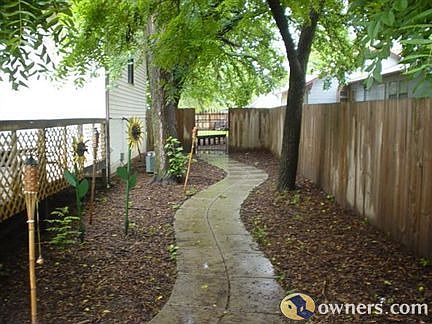 Concrete Walkway to Spacious Fenced-In Yard