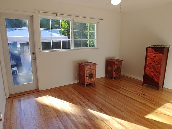 Bedroom with private bath and door to backyard.