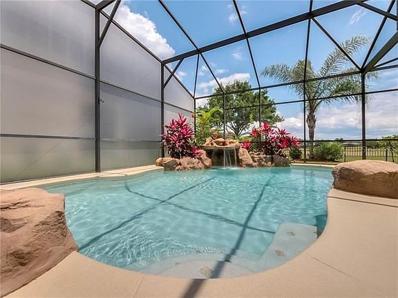 Amazing privacy side screens! Beautiful water fall feature, step in pool and golf course views!