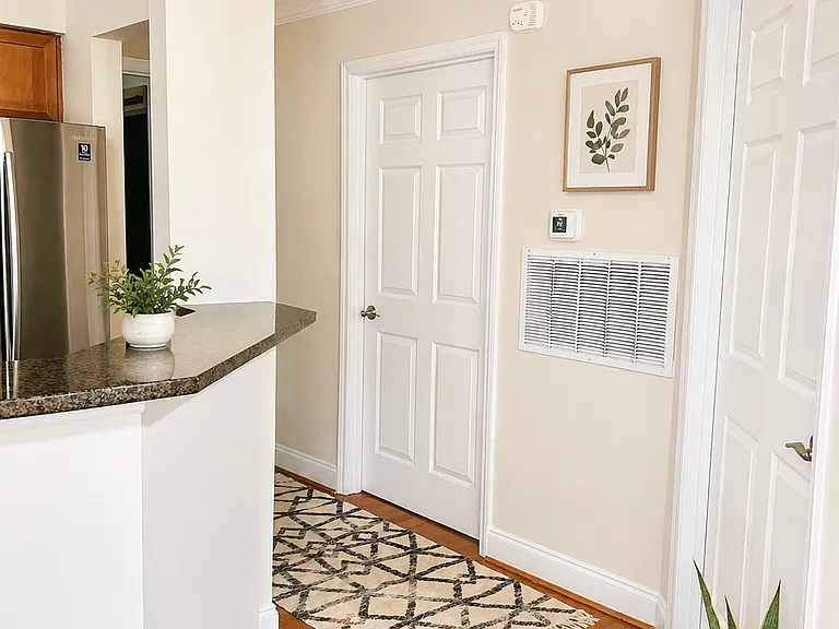 Hallway, first door is guest room, second is guest bathroom with laundry inside.