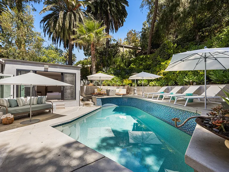 Beckoning with sparkling waters, the pool provides a welcome escape from the heat on sunny days.