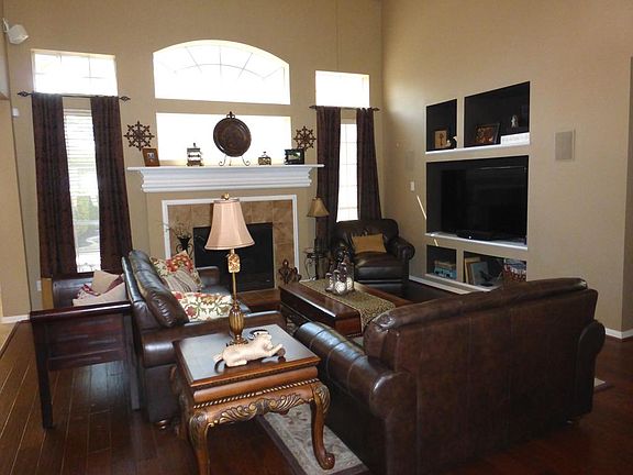 Two Story Den with Hardwoods, Gas Log Fireplace and Oversized Entertainment Built-in to hold A Apx. 60-65 Inch Flatscreen TV.