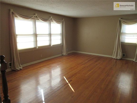 The living room boasts lots of natural light and stunning original hardwood floors!