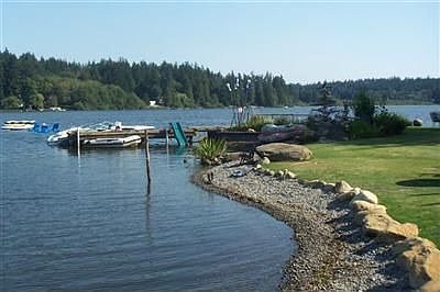 Your own private and sunny point w/dock and pebble beach for all of your water sports.