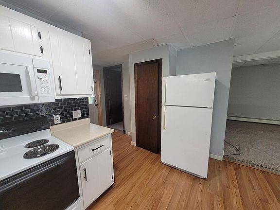 Going around the apartment is a living room to the right of the kitchen