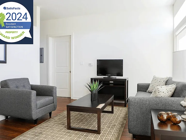 Metro Crossing Apartments Living Room Interior with Resident Satisfaction Logo Banner