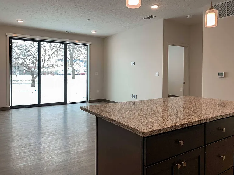 Relaxation meets culinary creativity, where the heart of the home basks in the glow of expansive windows and open space.