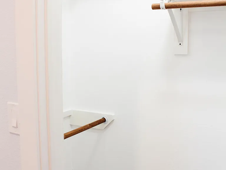Lots of space in your walk-in bedroom closet with lighting. Shelves and several clothing rods.