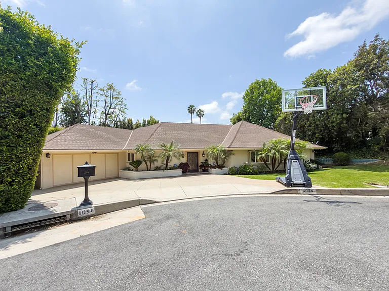 Wide circular driveway and a manicured front lawn welcome you to this Beverly Hills luxury rental at 1094 Garden Lane, a distinguished 90210 home for rent.