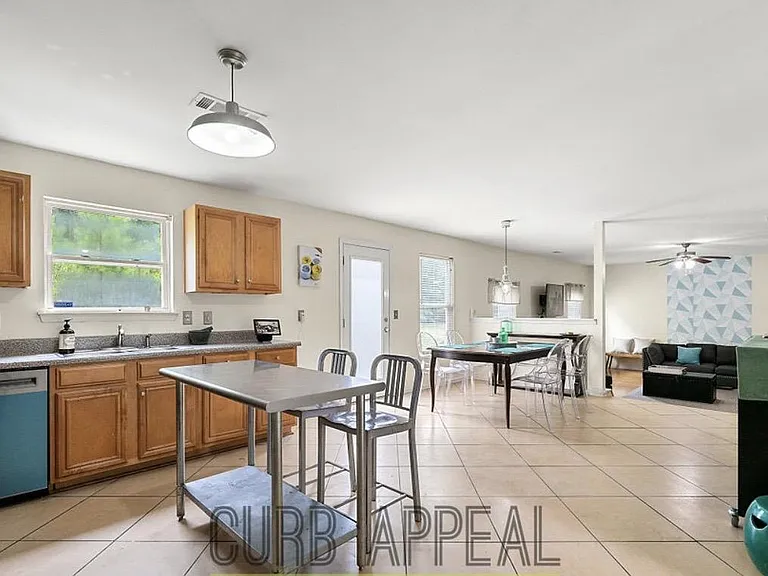 Open-concept kitchen with generous cabinet storage, counter space, and a casual eat-in area that flows into the living space.