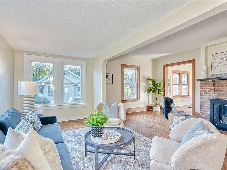 Large living room with decorative fireplace.