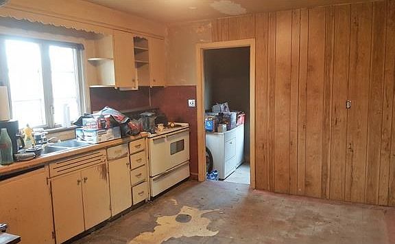 Kitchen leading to laundry room and utility closet