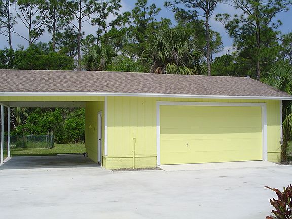 OVERSIZED 2 CAR GARAGE AND CARPORT WITH CONCRETE DRIVEWAY