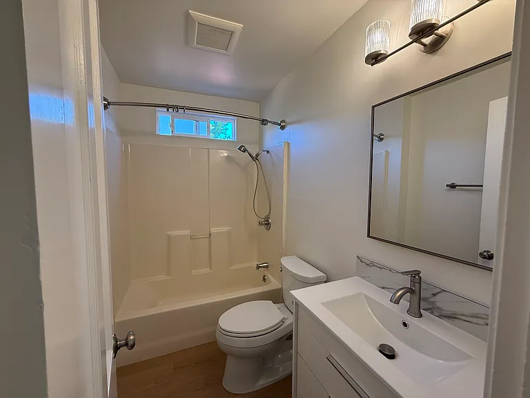 The hallway bathroom is tastefully appointed updated fixtures.