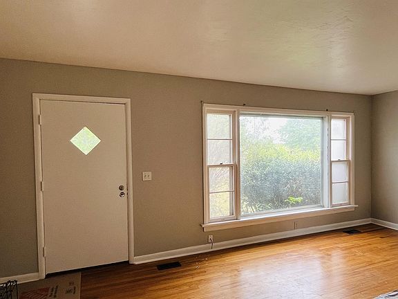 Front door and living area with wonderful natural light from the large front window.
