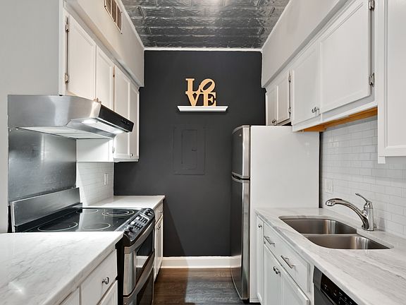 Updated kitchen features quartz countertops, stainless steel appliances, and ample cabinet space for both everyday living and entertaining.
