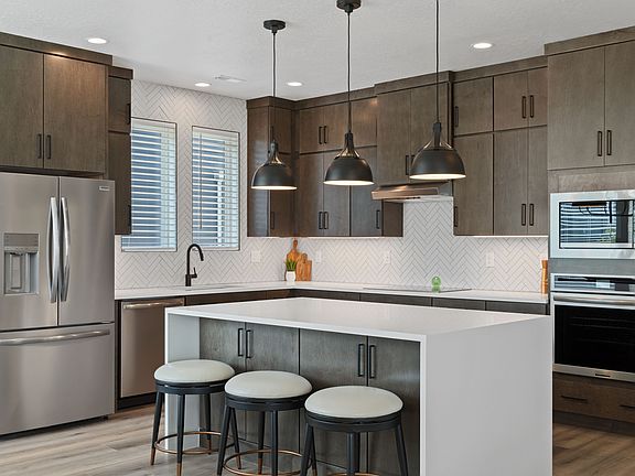 Located in the heart of Cascade Village, this modern kitchen boasts wooden cabinets, stainless steel