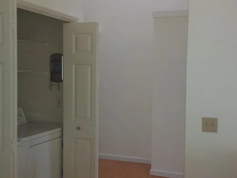 Entryway from step to laundry room and bedrooms