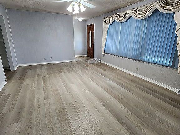 Living room w/ main entry.