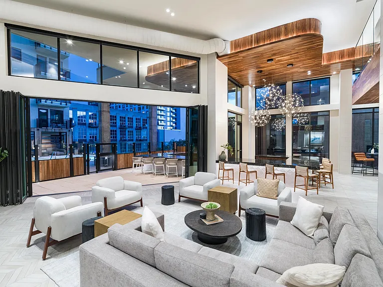 This sophisticated clubroom effortlessly blends elegant interiors with an inviting outdoor patio.