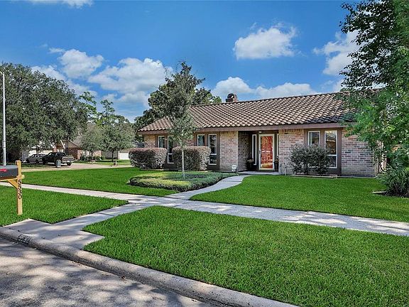 This manicured and well-maintained home has a Monier concrete tile roof, and brick on all sides of the home.