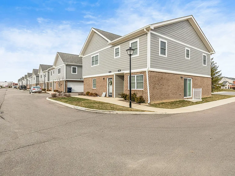 Classic style and thoughtful design _ this townhome corner view showcases Hamilton Station's charming architecture and well-kept surroundings.