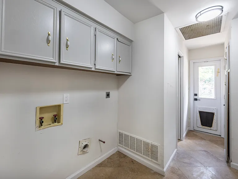 Laundry with half bath adjacent