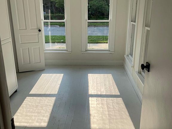 Cheerful sunroom. Could be an office or guest room.