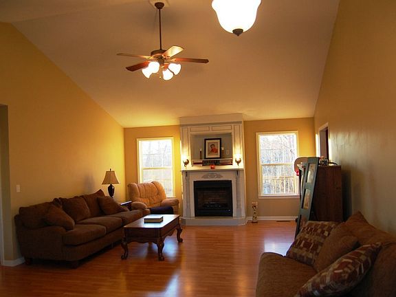 Large living room with valted ceiling and gas fireplace