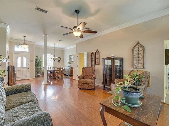 Views of Open Formal Living & Dining Rooms with Wood Floors & Plantation Shutters